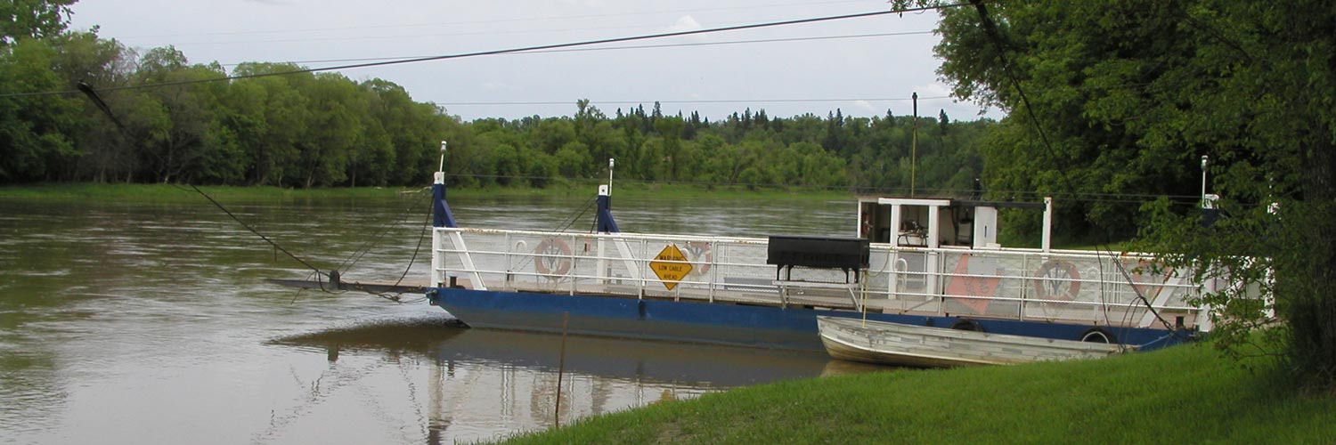 The Stockton Ferry on the Assiniboine River northwest of Glenboro, Manitoba. The ferry is blue with white railings and operates on an overhead cable system.